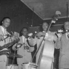 Four musicians with instruments holding Arrow Beer, circa 1951. Paul Henderson, HEN.00.A2-255.