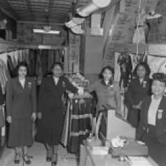Women inside clothing store, circa 1953. Paul Henderson, HEN.00.B1-106.