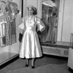 Unidentified woman inside clothing store, circa 1951. Paul Henderson, HEN.00.B1-107.