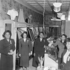 Women inside clothing store, circa 1953. Paul Henderson, HEN.00.B1-132.